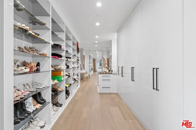 a hallway with white cabinets