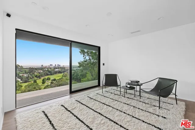 a living room with a large window and a table