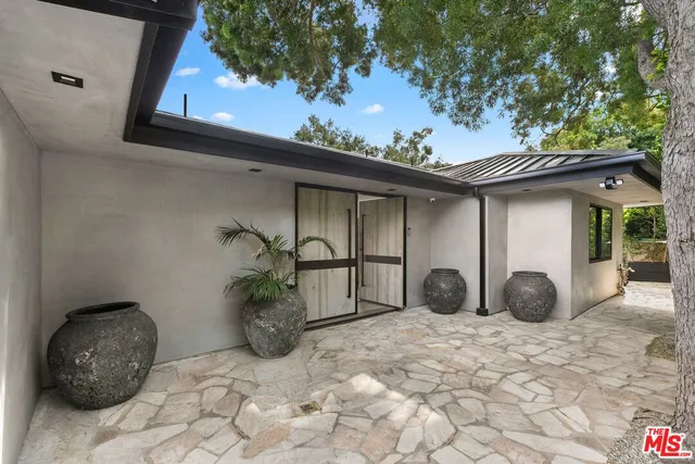 a backyard of a house with table and chairs