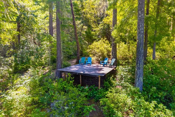 a view of a chairs and table in the garden