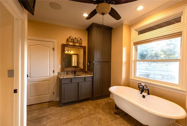 a spacious bathroom with a sink and a mirror