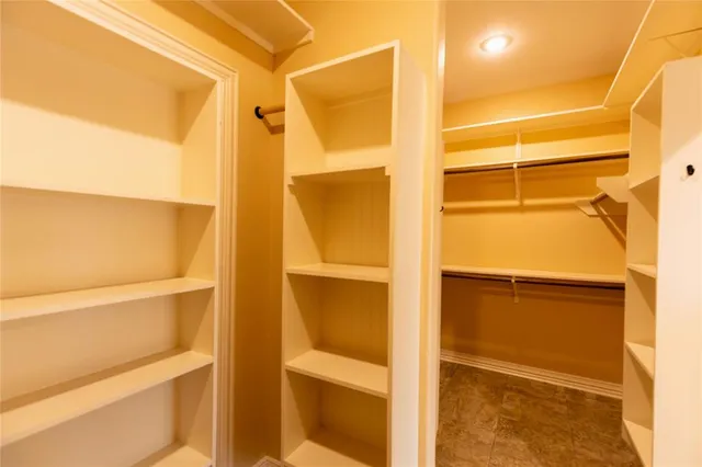 a view of a room with wooden floor and door