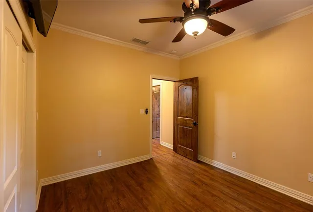 a bathroom with a granite countertop bathtub sink vanity mirror and toilet