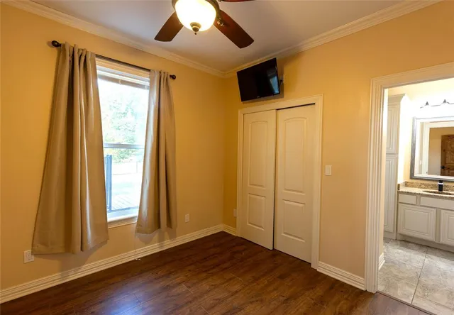 a bathroom with a granite countertop bathtub shower sink vanity and toilet