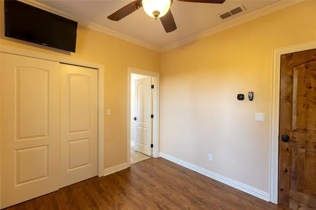 a view of an empty room with a fan