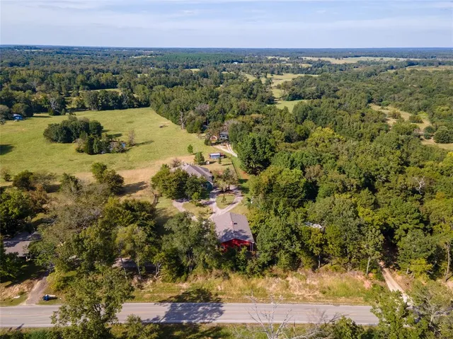 a view of a room with wooden floor chandelier and a window