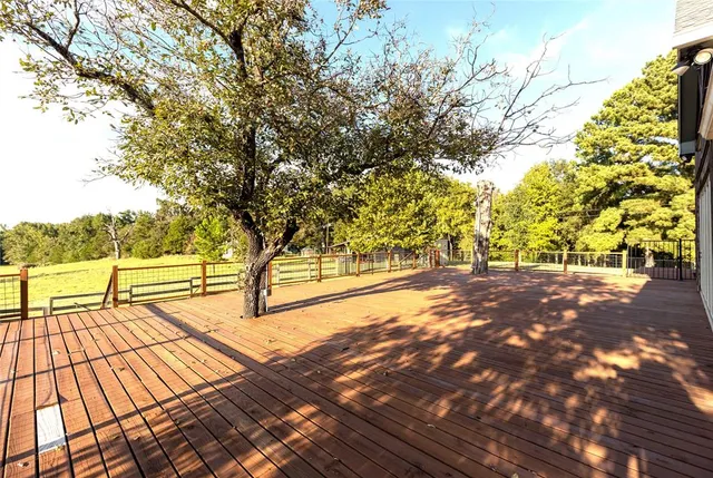 a front view of a house with wooden deck