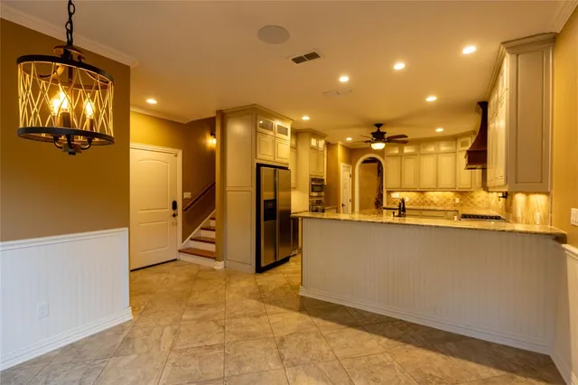 a view of an empty room with a window and a ceiling fan