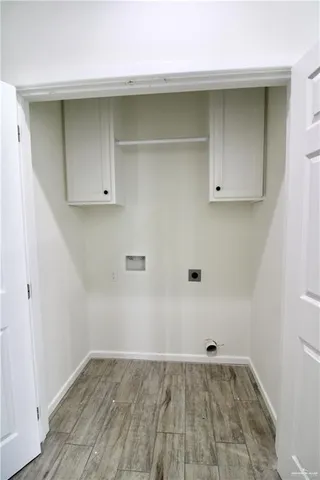 a view of a room with wooden floor and cabinet