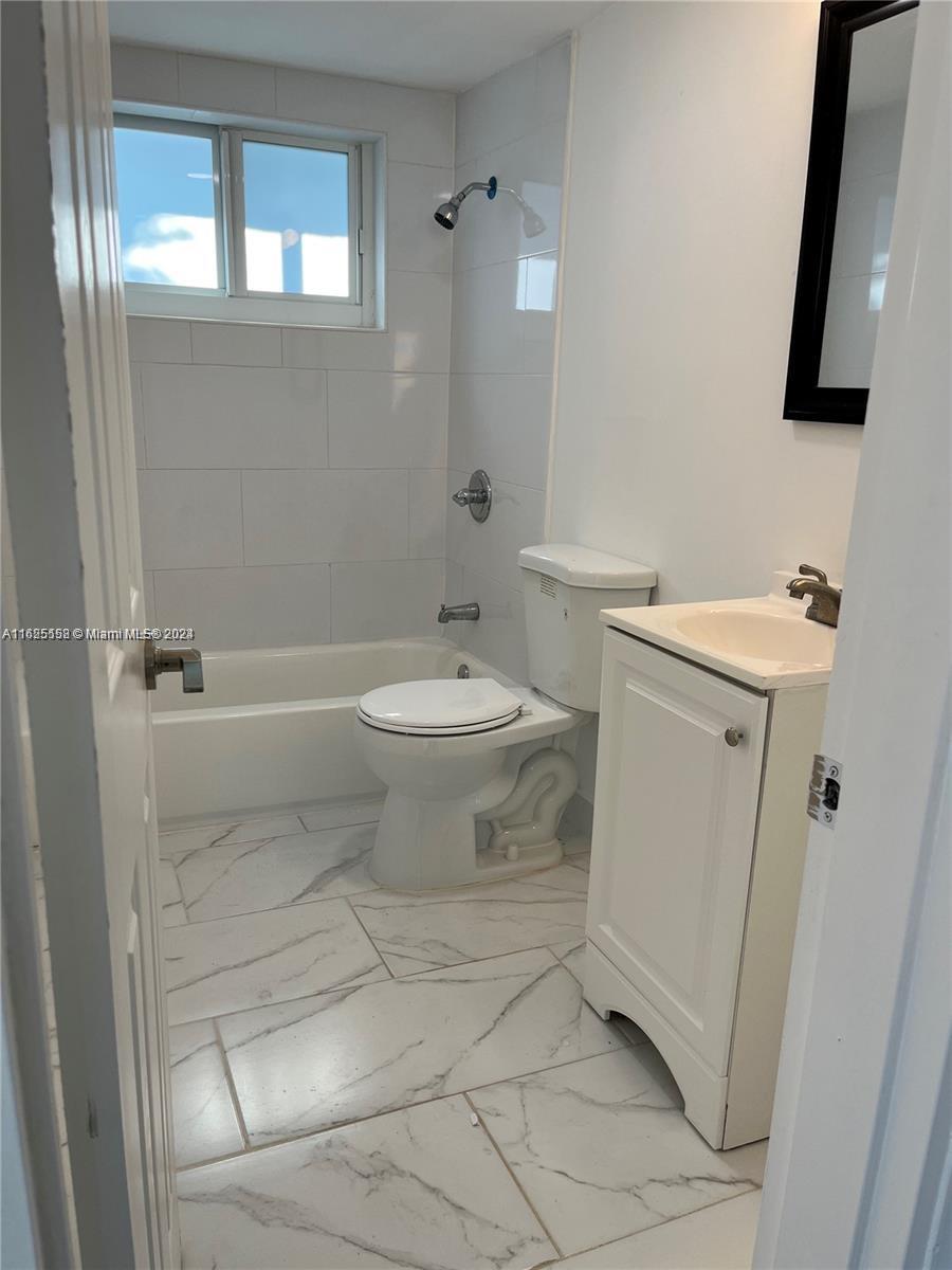 14280 Northeast 6th Avenue North Miami, FL 33161 - Photo 12 of 51 a bathroom with a toilet sink and mirror