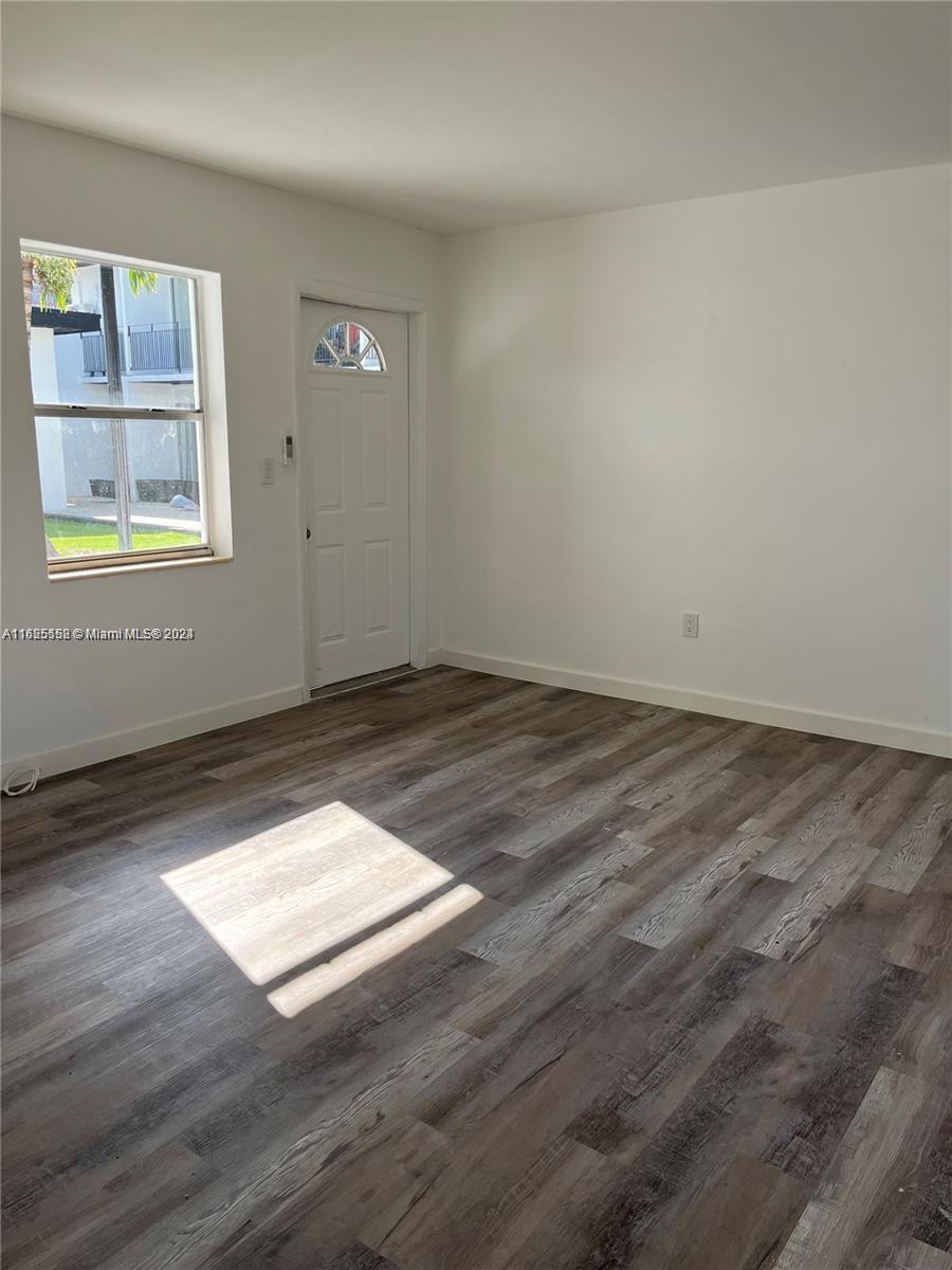 14280 Northeast 6th Avenue North Miami, FL 33161 - Photo 14 of 51 an empty room with wooden floor and windows
