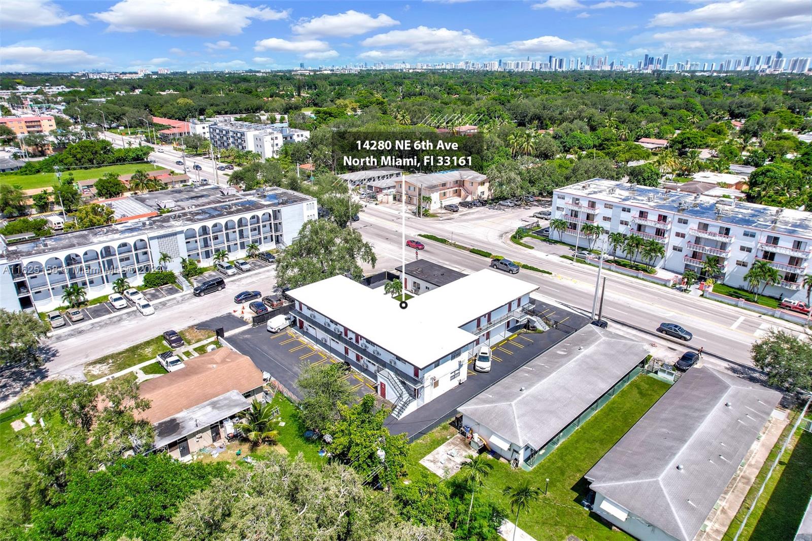 14280 Northeast 6th Avenue North Miami, FL 33161 - Photo 19 of 51 an aerial view of a city with lots of residential buildings and mountain view in back