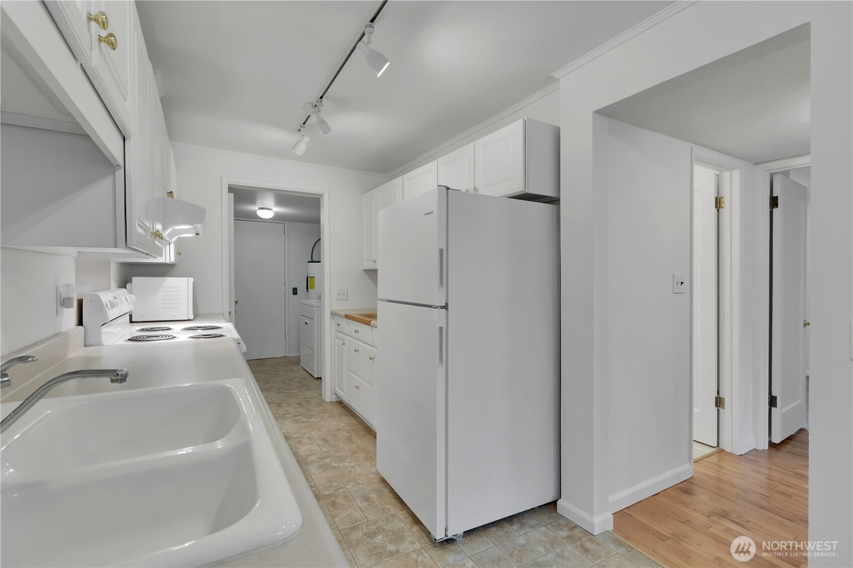 10421 2nd Place Southwest Seattle, WA 98146 - Photo 12 of 28 a kitchen with stainless steel appliances a refrigerator and a sink