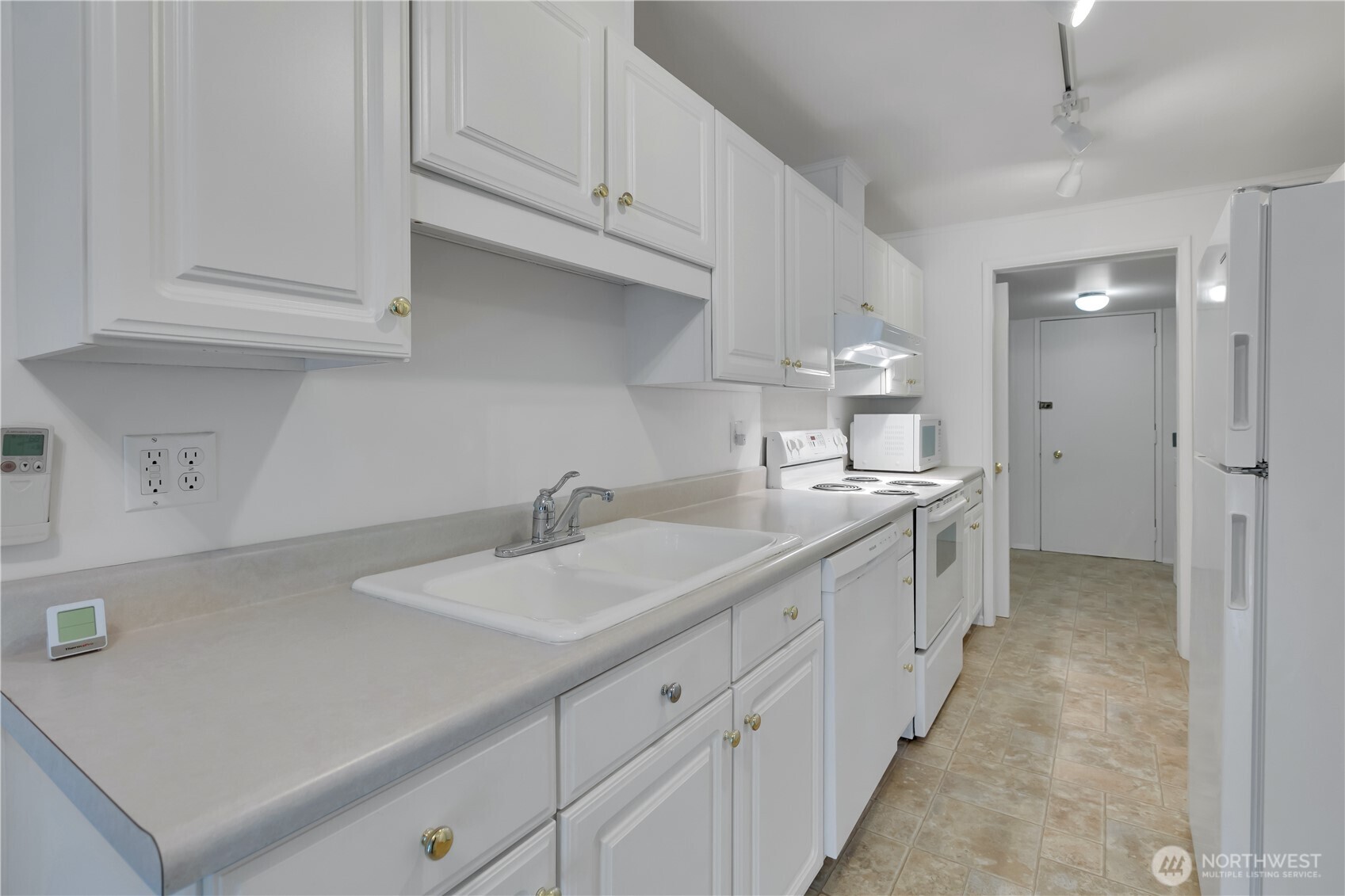 10421 2nd Place Southwest Seattle, WA 98146 - Photo 14 of 28 a kitchen with granite countertop white cabinets and sink