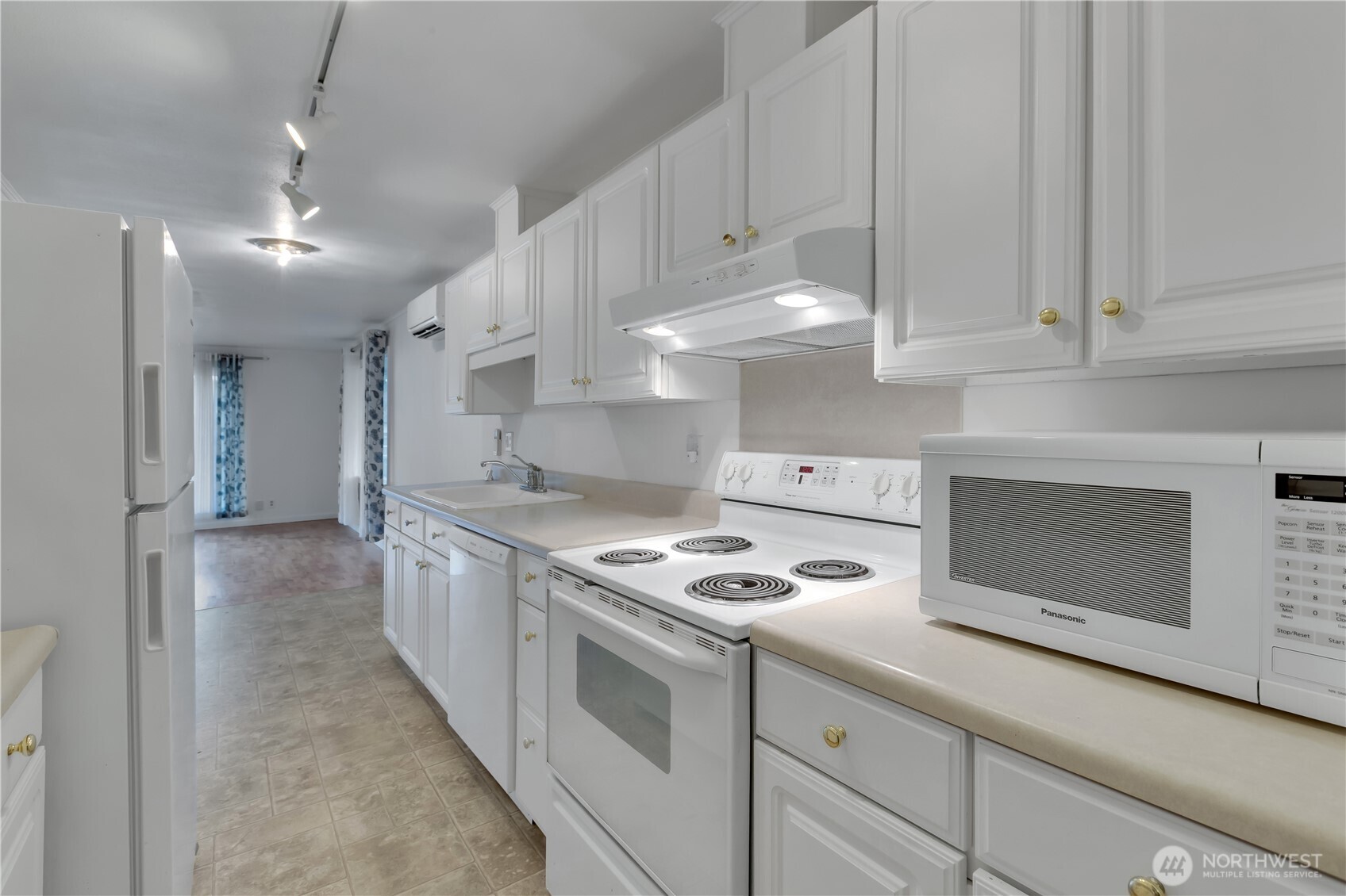 10421 2nd Place Southwest Seattle, WA 98146 - Photo 15 of 28 a kitchen with granite countertop cabinets stainless steel appliances and a fireplace