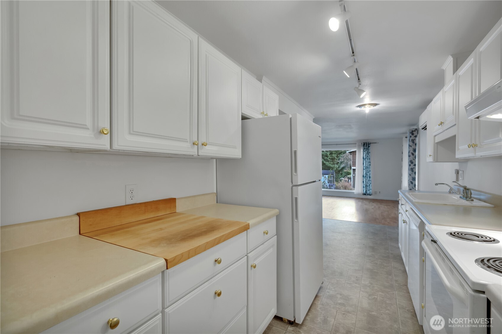 10421 2nd Place Southwest Seattle, WA 98146 - Photo 16 of 28 a kitchen with a sink a stove and refrigerator
