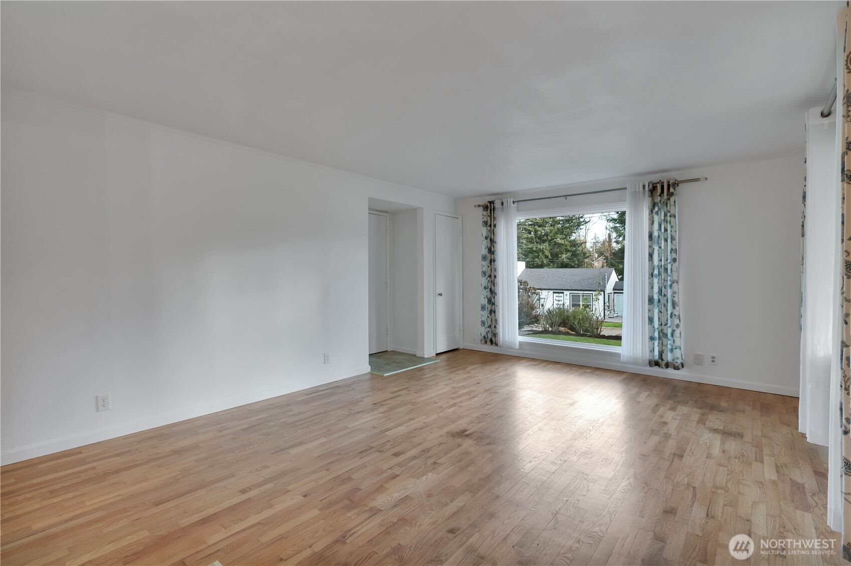 10421 2nd Place Southwest Seattle, WA 98146 - Photo 8 of 28 a view of a big room with wooden floor and windows