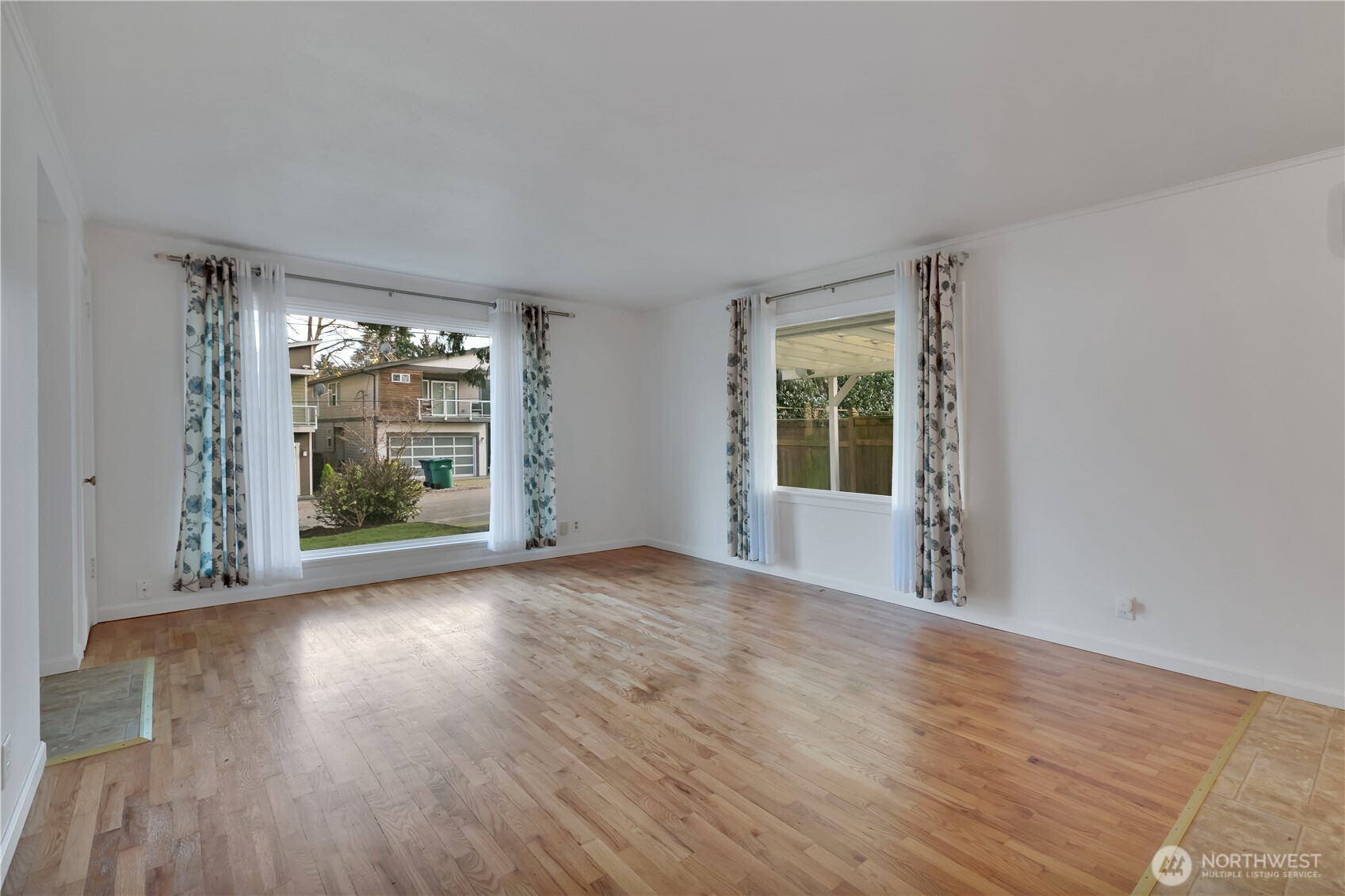 10421 2nd Place Southwest Seattle, WA 98146 - Photo 10 of 28 a view of an empty room with wooden floor and a window