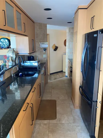 a kitchen with a refrigerator and a sink