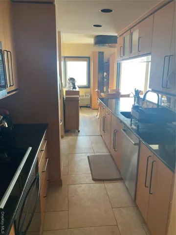 a large kitchen with a stove a sink and a refrigerator