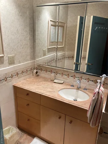 a bathroom with a double vanity sink and a mirror