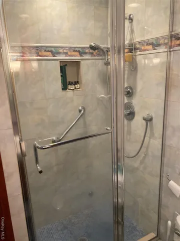 a bathroom with a glass shower door