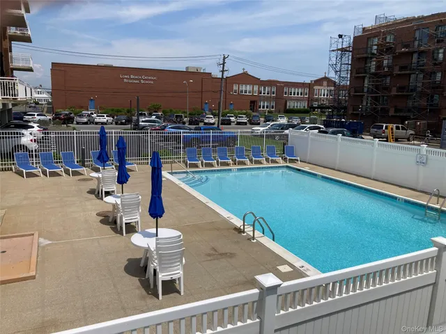 a view of a swimming pool with a chair and couches