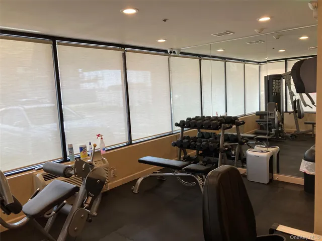 a room with gym equipment and a large window