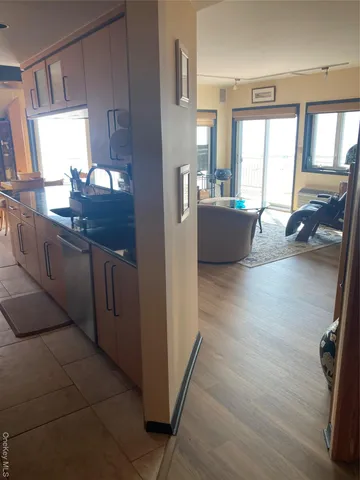 a kitchen with stainless steel appliances granite countertop a sink counter space and a large window