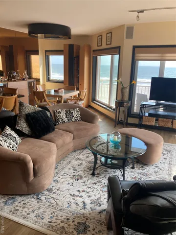 a living room with furniture and a large mirror