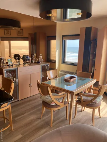 a dining room with furniture and wooden floor