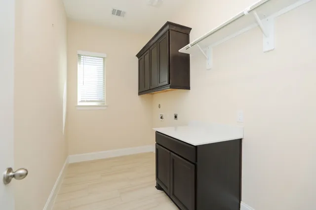 a kitchen with stainless steel appliances granite countertop a sink counter space cabinets and wooden floor