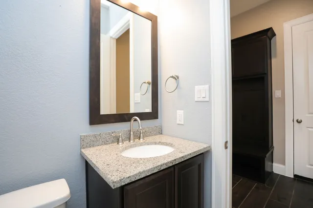 a large kitchen with stainless steel appliances kitchen island granite countertop a large counter top and wooden floors