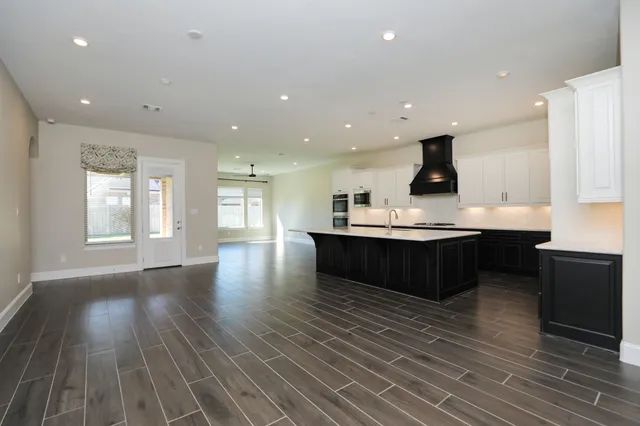 a kitchen with stainless steel appliances granite countertop a sink counter space and cabinets