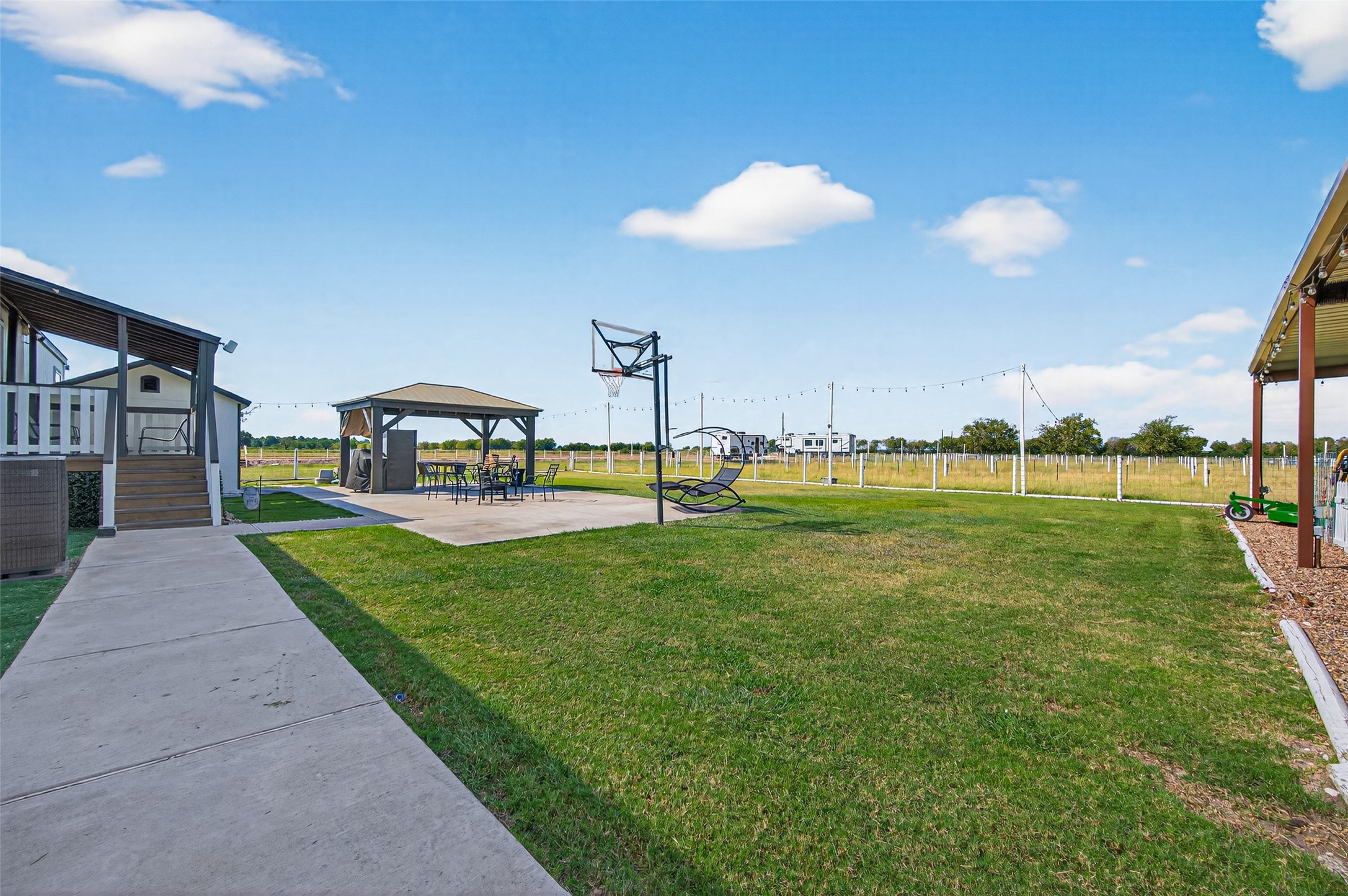 805 Williams Road East Bernard, TX 77435 - Photo 30 of 47 Spacious outdoor living area with gazebo, concrete patio, and open yard—perfect for gatherings and enjoying wide-open country views.