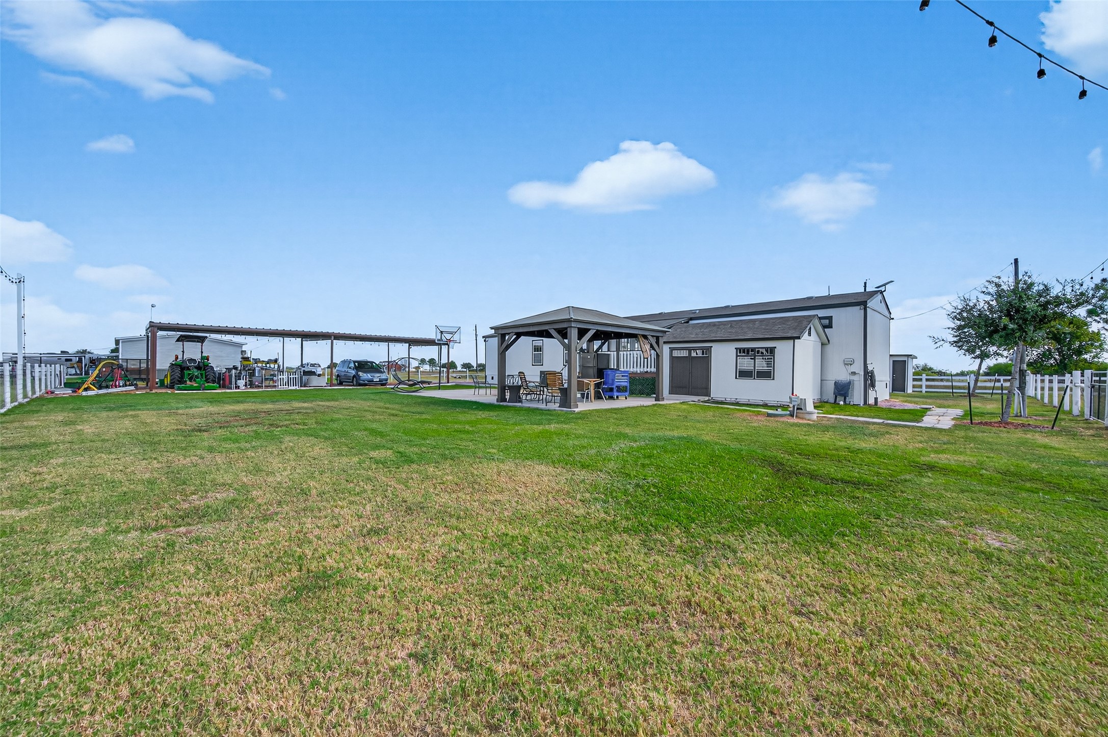 805 Williams Road East Bernard, TX 77435 - Photo 37 of 47 Wide view of the property showcasing open green space, gazebo, and outbuildings—highlighting the peaceful rural setting and usable acreage.
