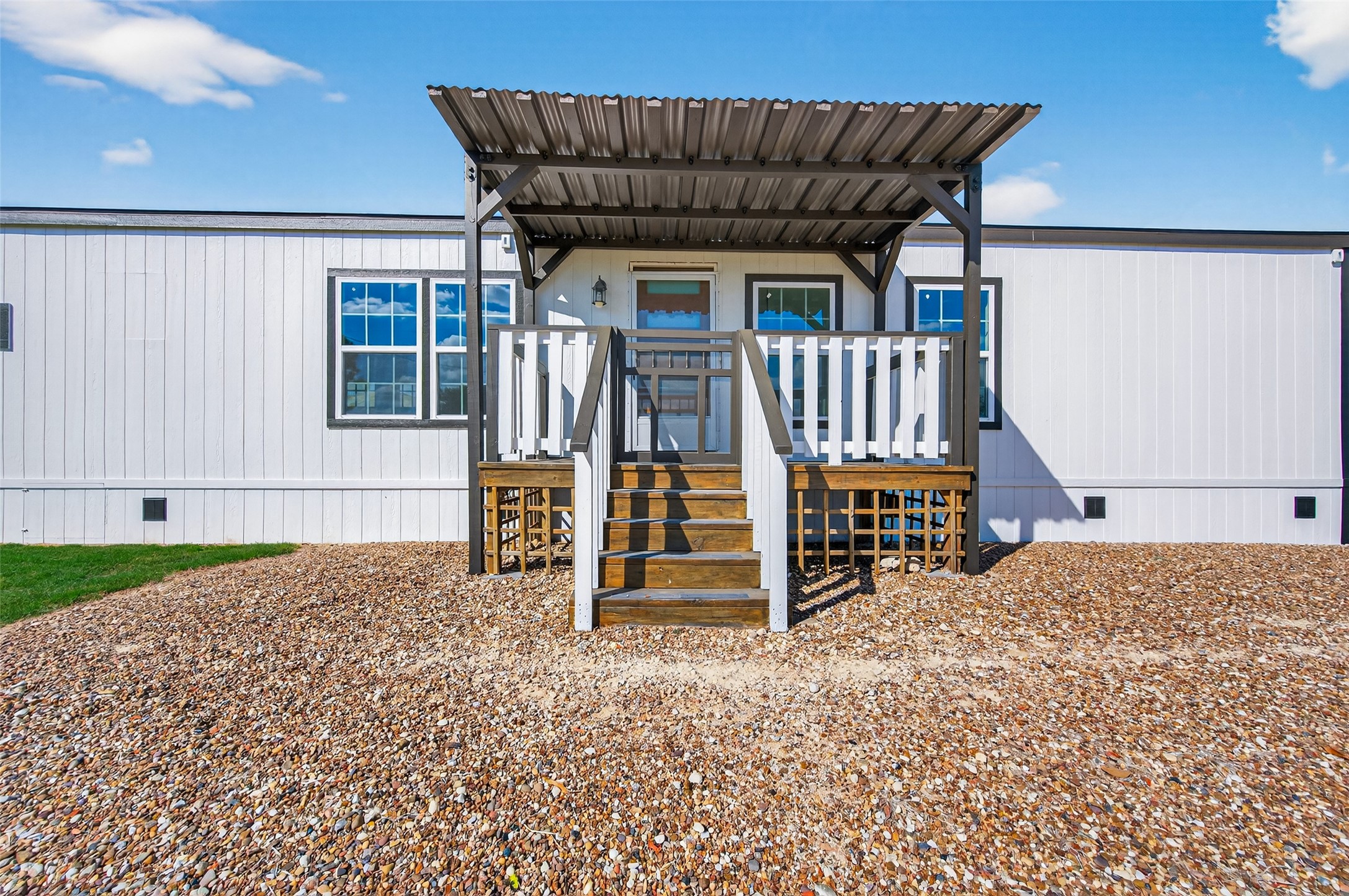 805 Williams Road East Bernard, TX 77435 - Photo 7 of 47 Front entry with a covered porch, metal roof, and welcoming steps—adding rustic charm to this country home.