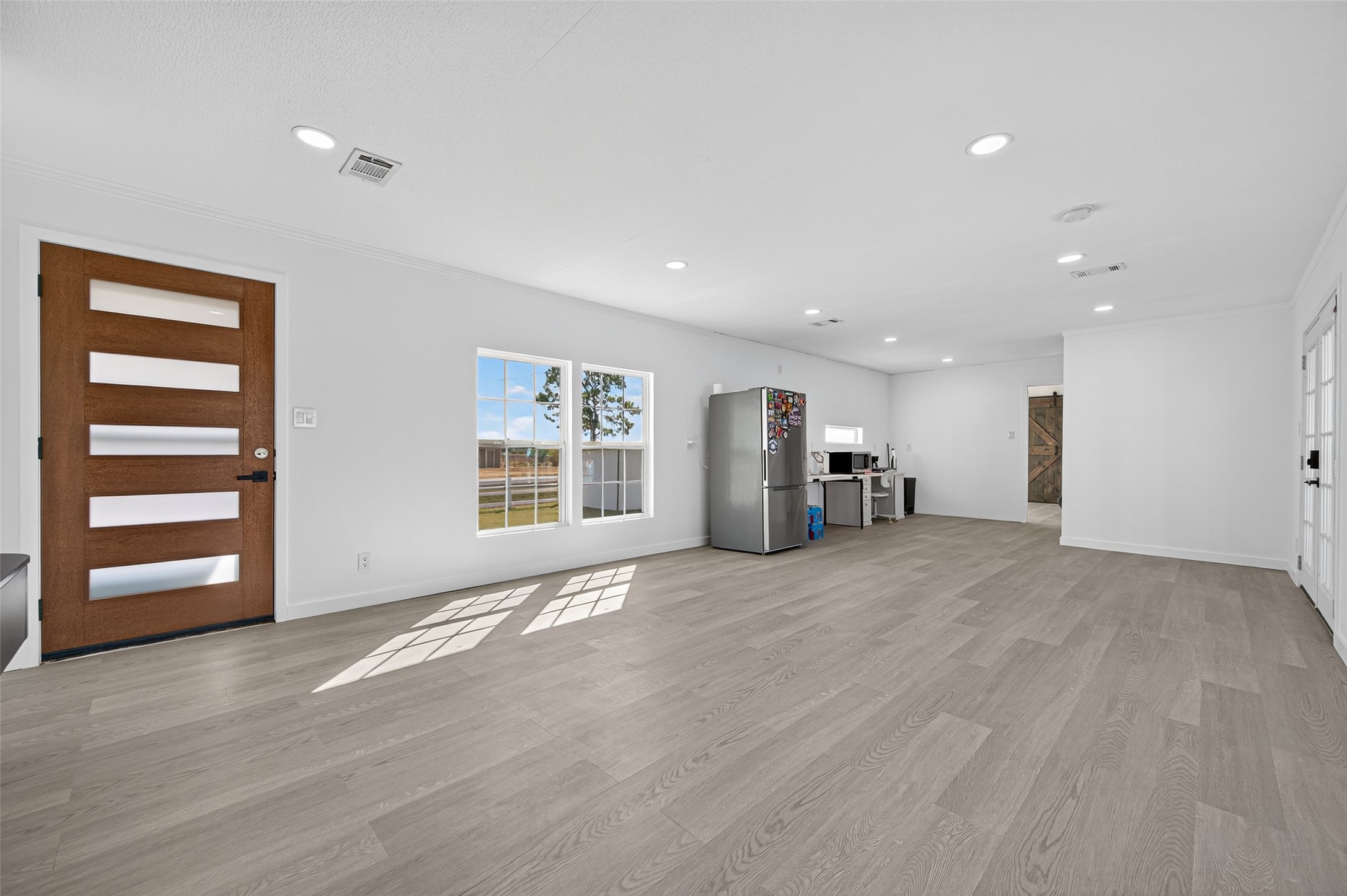 805 Williams Road East Bernard, TX 77435 - Photo 10 of 47 Bright, open-concept living space featuring wide plank flooring, recessed lighting, and abundant natural light—perfect for flexible living and entertaining.