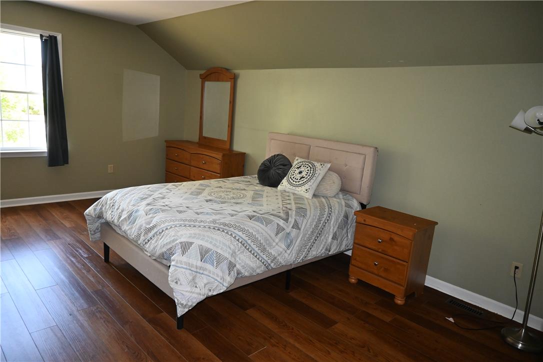 3829 East Hopewell Road Center Valley, PA 18034 - Photo 39 of 52 Rich hardwood floors create a welcoming atmosphere in this spacious bedroom, ideal for relaxation.