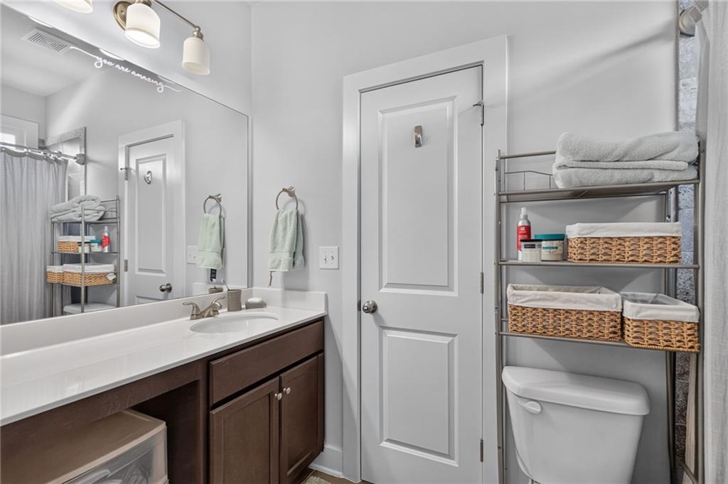 139 Manchester Lane Villa Rica, GA 30180 - Photo 39 of 60 a bathroom with a sink a toilet and a mirror