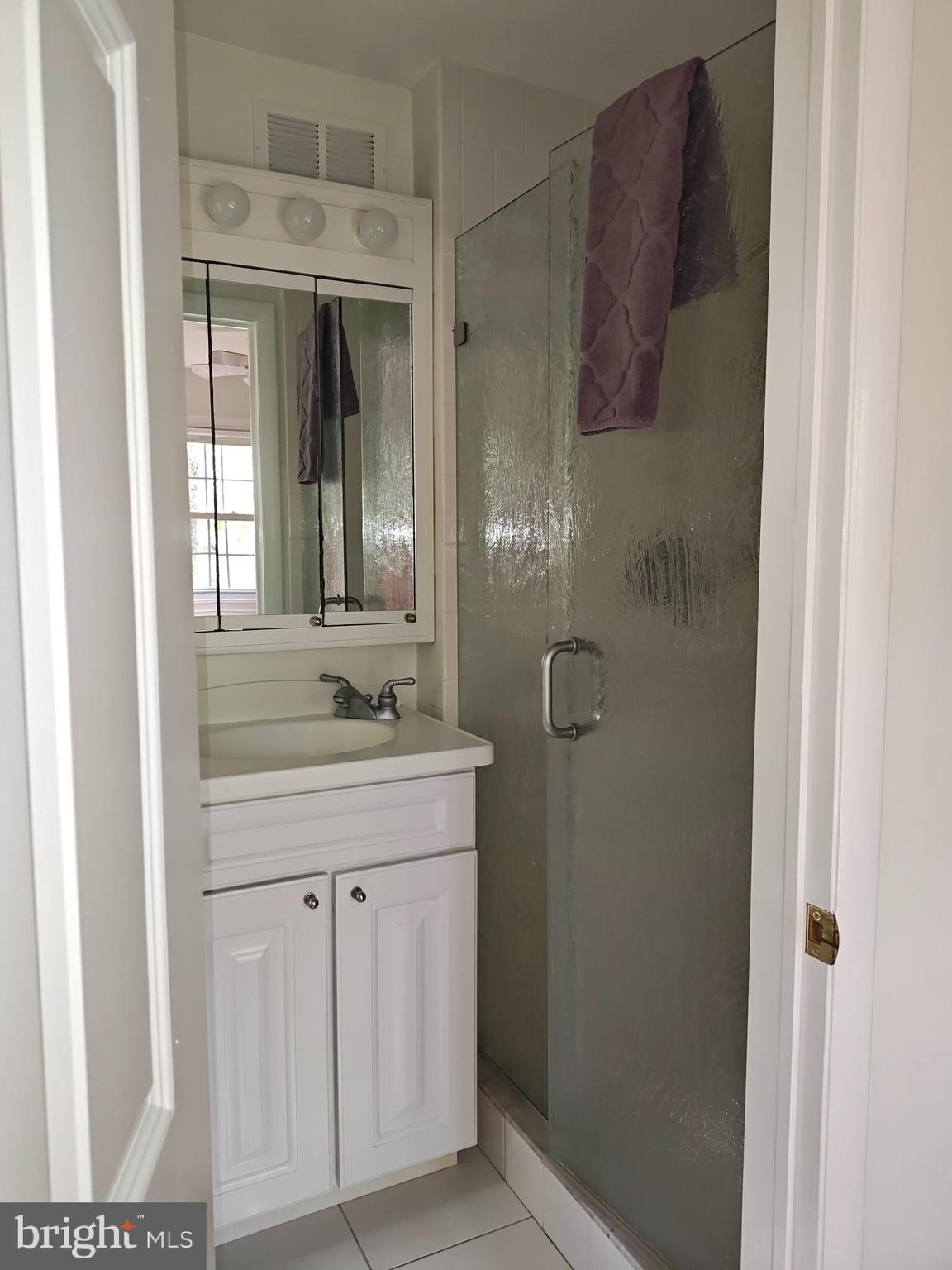 572 Cricket Lane Wayne, PA 19087 - Photo 26 of 37 a bathroom with a granite countertop sink a mirror and shower