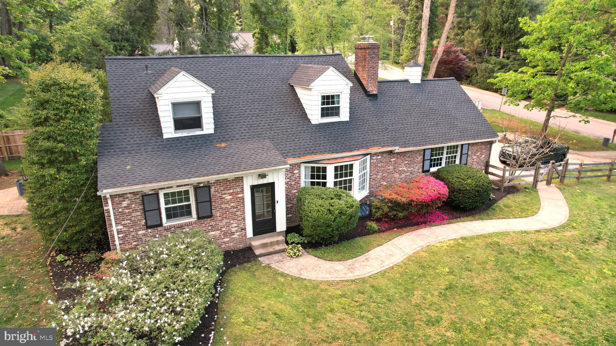 572 Cricket Lane Wayne, PA 19087 - Photo 3 of 37 a front view of a house with a yard and garage