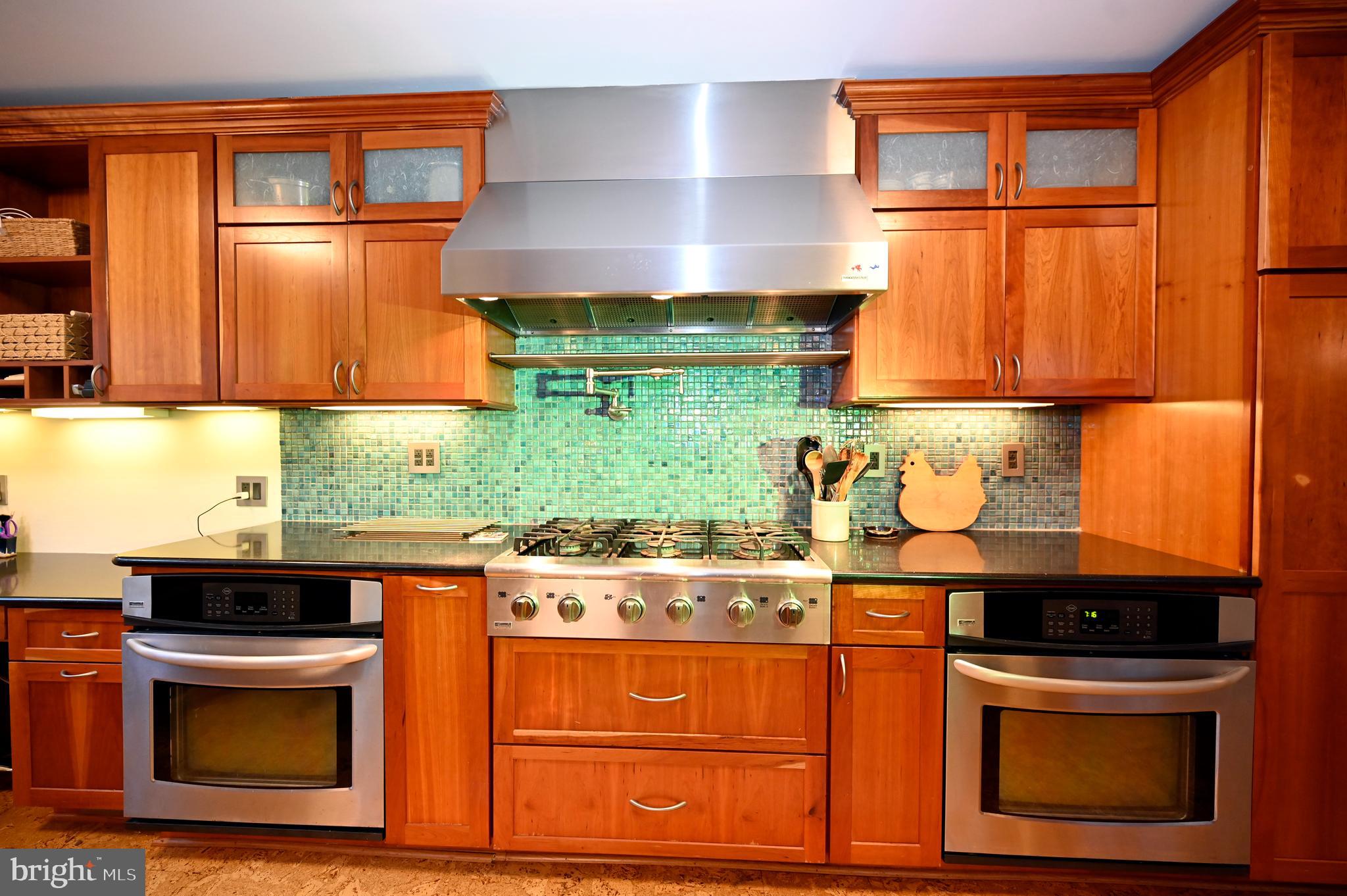 572 Cricket Lane Wayne, PA 19087 - Photo 9 of 37 a kitchen with stainless steel appliances granite countertop a stove and a microwave