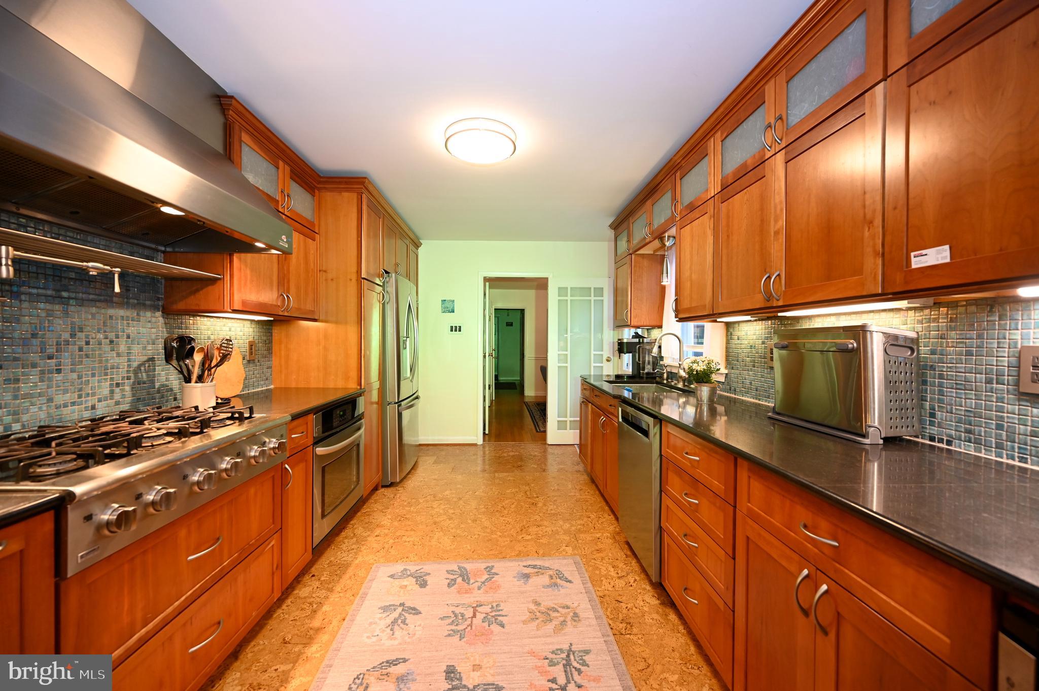 572 Cricket Lane Wayne, PA 19087 - Photo 10 of 37 a kitchen with stainless steel appliances granite countertop a stove a sink and a refrigerator