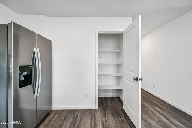 a view of walk in closet with wooden floor and closet