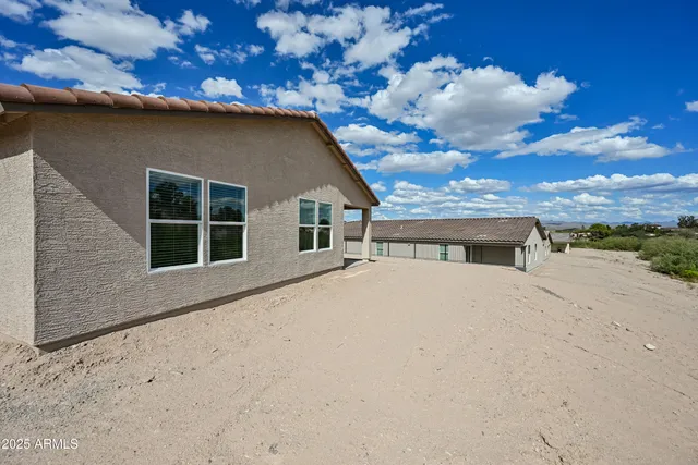 a big house with large trees in the background