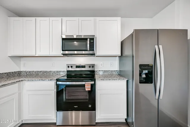 a kitchen with cabinets and stainless steel appliances