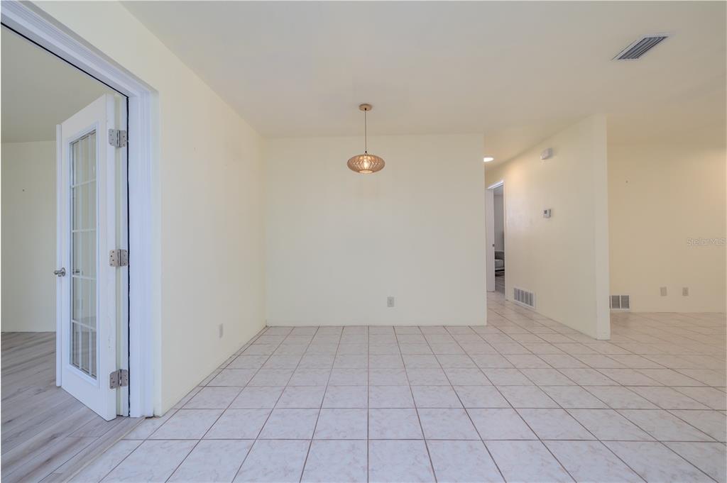1016 Cherokee Ranch Road Holly Hill, FL 32117 - Photo 5 of 23 an empty room with white walls and tiles