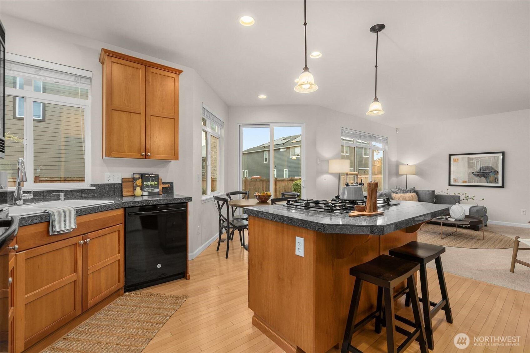 16101 Southeast 251st Street Covington, WA 98042 - Photo 14 of 32 a kitchen with stainless steel appliances granite countertop sink stove and wooden cabinets
