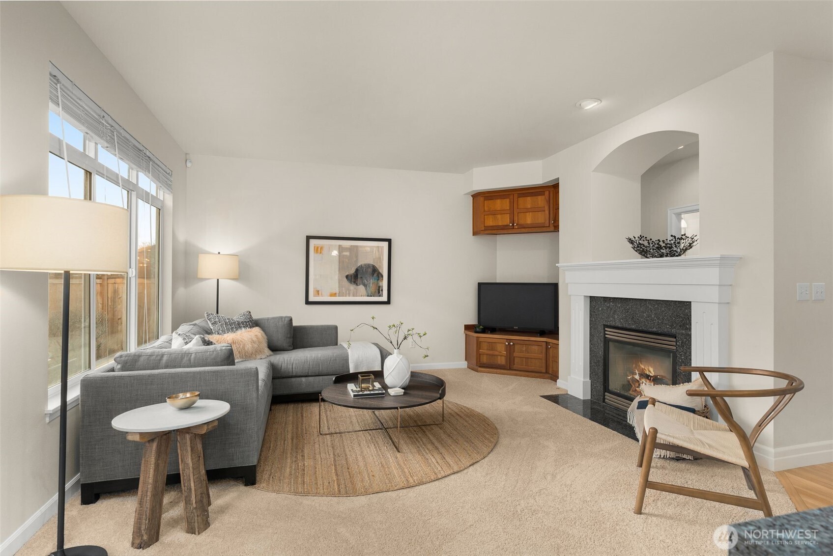 16101 Southeast 251st Street Covington, WA 98042 - Photo 10 of 32 a living room with furniture a fireplace and a large mirror